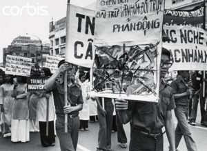 29 May 1975, Ho Chi Minh City, Vietnam --- Saigon students demonstrate against "Depraved and Reactionary Culture" as part of the book burning campaign in South Vietnam. Estimated tens of thousands of books and recordings have been destroyed by student's bonfires and private destruction since the campaign began 5/21. Virtually all bookstores have been closed down by the edict against sale of books and recordings made during the time of previous regime. Picture was taken 5/29 in Saigon. --- Image by © Bettmann/CORBIS